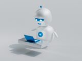 a white robot with blue eyes and a laptop