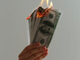 time lapse photography of several burning US dollar banknotes