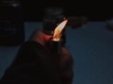 person holding lighter with fire