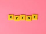 Yellow block letters spelling 'error' on a vibrant pink background, capturing a playful message.