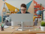 Man working on computer in colorful home office