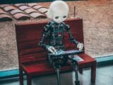 black and white robot toy on red wooden table