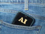 Smartphone with ai text in jeans pocket