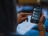 Woman using a smartphone with a smart home app.