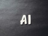 the word ai spelled in white letters on a black surface