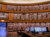 brown wooden book shelves in library