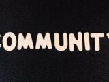 the word community written in white on a black background