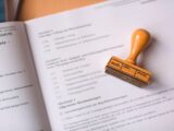 brown wooden hand tool on white printer paper