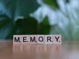 A wooden block spelling memory on a table