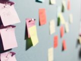 colorful sticky notes pinned to board