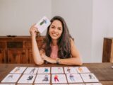 woman in white and black tank top holding white printer paper