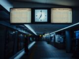 Train station platform with clock and departure boards