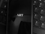 black laptop computer turned on with black textile