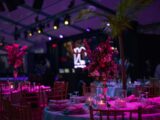a table set up for a party with candles and flowers