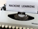 a close up of a typewriter with a paper reading machine learning