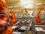 a factory filled with lots of orange machines