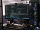 a computer monitor sitting on top of a desk