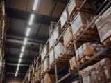brown cardboard boxes on white metal rack