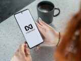 Woman holding smartphone with ai workspace logo.